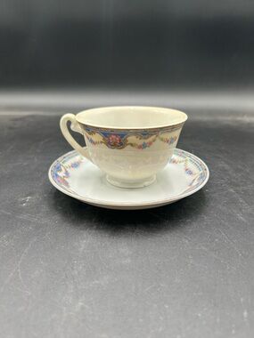 Gold China Japan Ivory Porcelain Teacup and Saucer with Floral Border